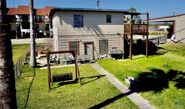 a view of a house with backyard and sitting area
