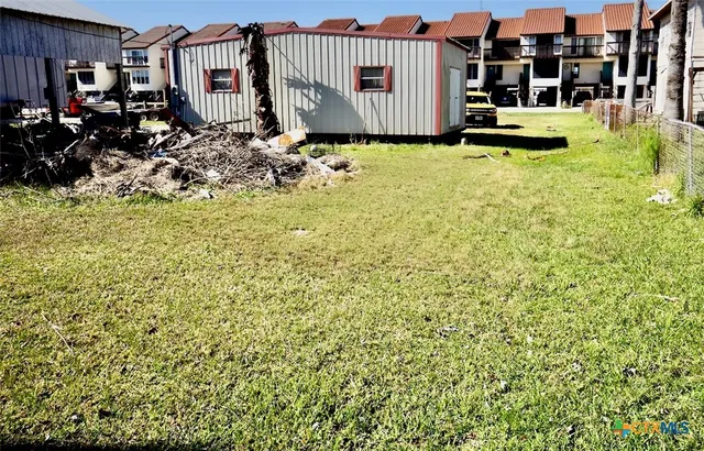 a view of swimming pool outdoor seating and covered with trees