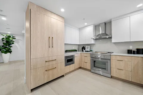 a bedroom with a bed and large window
