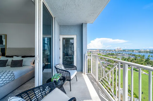 a living room with furniture kitchen view and a potted plant