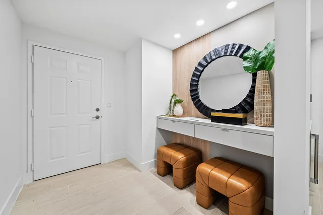 a living room with furniture and a potted plant