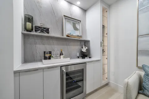 a kitchen with white cabinets and appliances