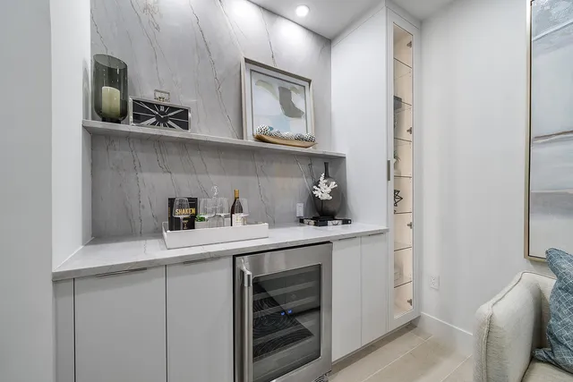 a kitchen with white cabinets and appliances