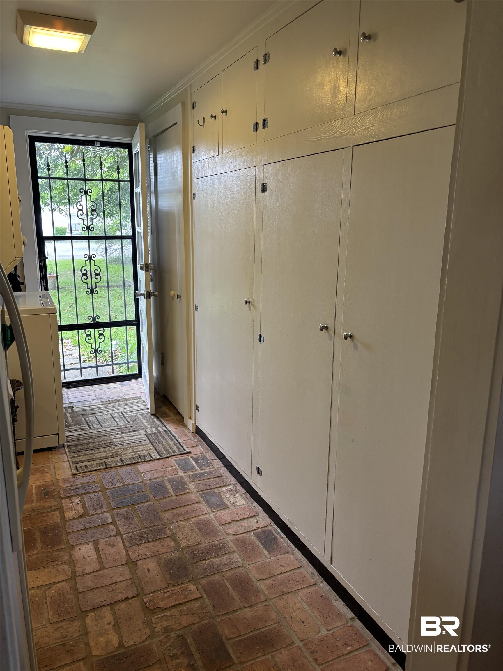 216 West Orange Avenue Foley, AL 36535 - Photo 10 of 37 Doorway with washer / clothes dryer and brick flooring