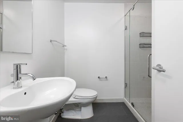 a white toilet sitting next to a bathroom sink