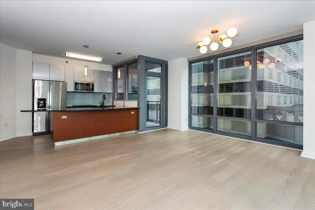 a view of kitchen with granite countertop cabinets and refrigerator