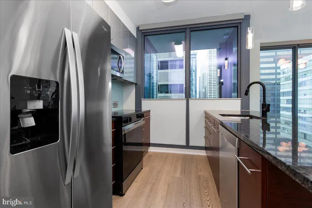 a kitchen with stainless steel appliances a refrigerator and a sink