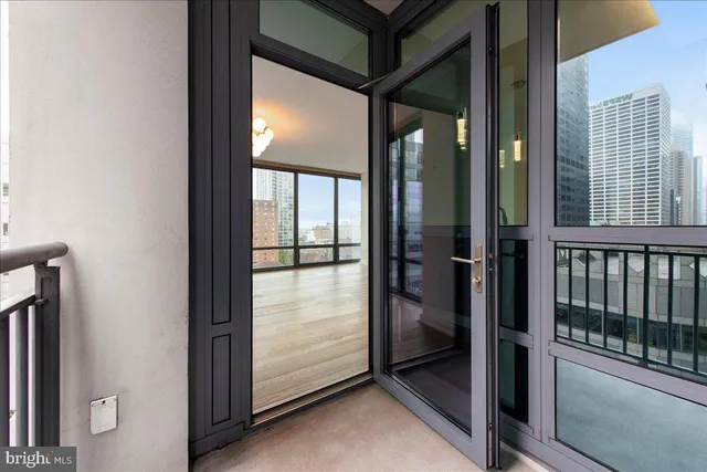 a view of a hallway with a glass door and shower