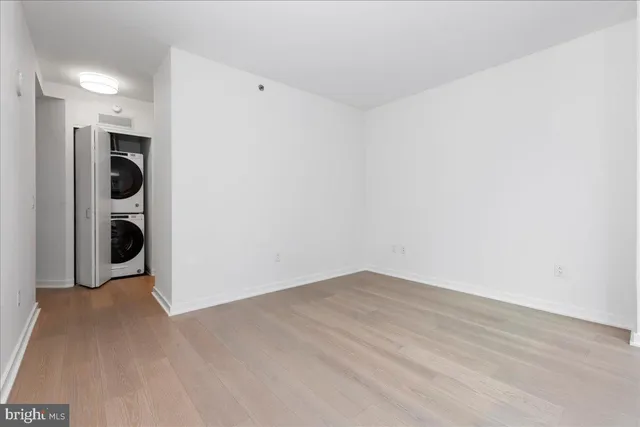 a view of a big room with wooden floor and cabinets