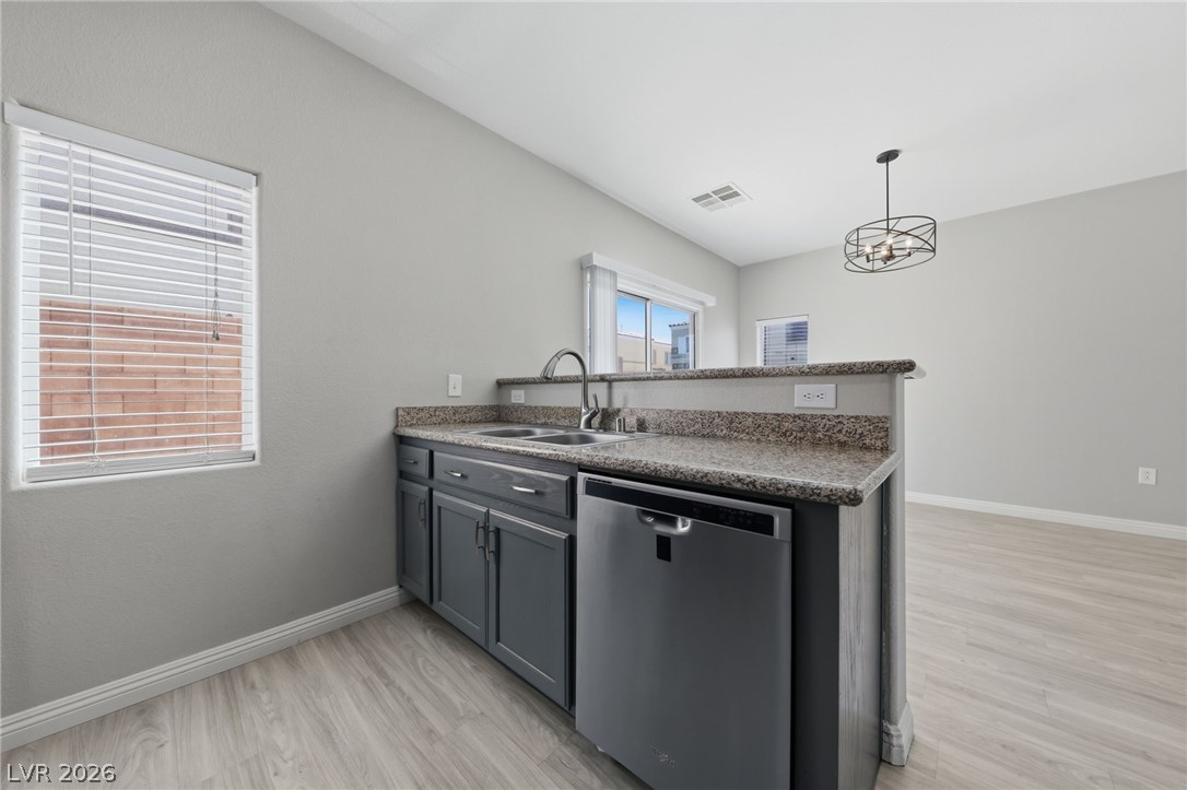 6312 Sandy Ridge Street, Unit 3102 North Las Vegas, NV 89081 - Photo 8 of 31 Granite counters and stainless steel appliances outfit this functional kitchen space, with a window offering natural light.