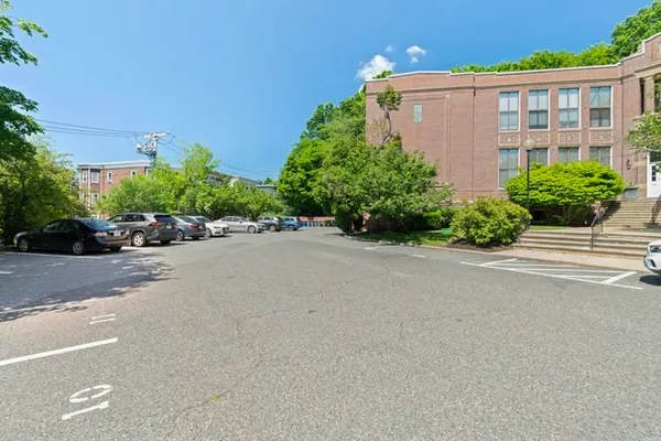 a view of a brick building next to a road