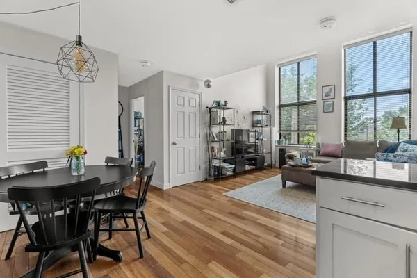 a view of a dining room with furniture window and wooden floor