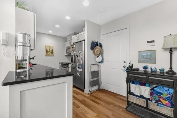 a kitchen that has a lot of cabinets and wooden floor