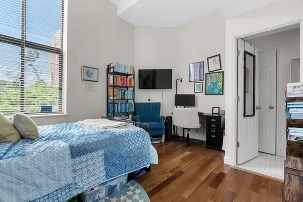 a bedroom with a bed and a flat screen tv