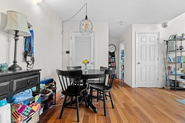 a view of a dining room with furniture and wooden floor