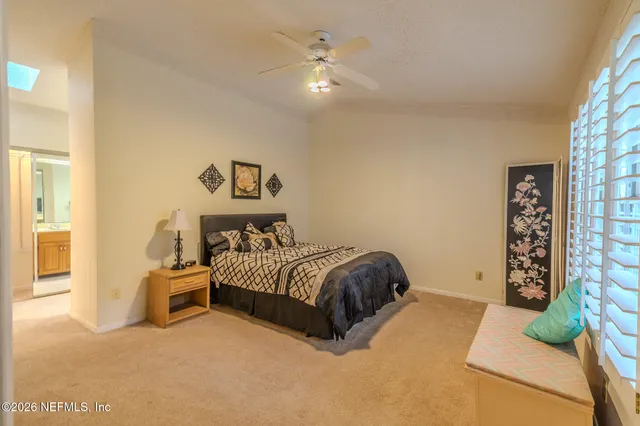 a spacious bedroom with a bed and a couch