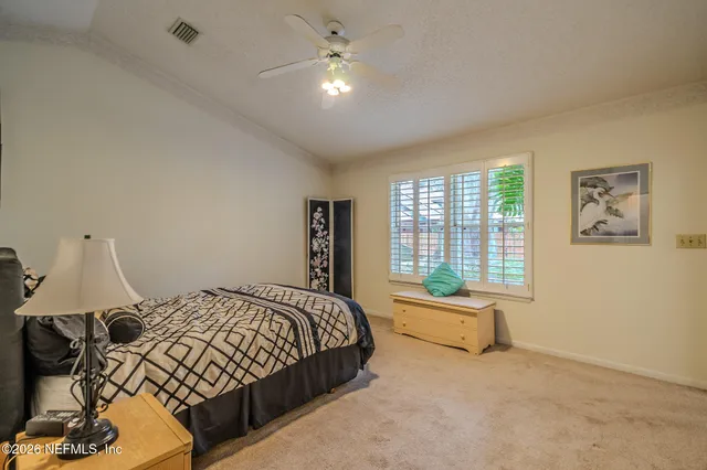 a bedroom with a bed and window