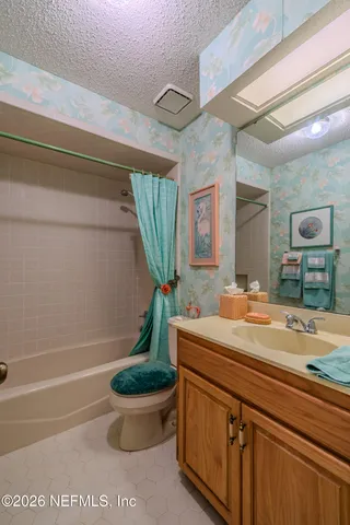 a bathroom with a sink a toilet and a shower