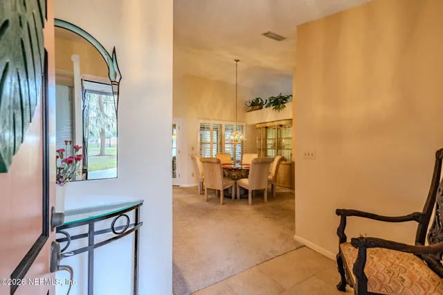 a view of a dining room with furniture and a window