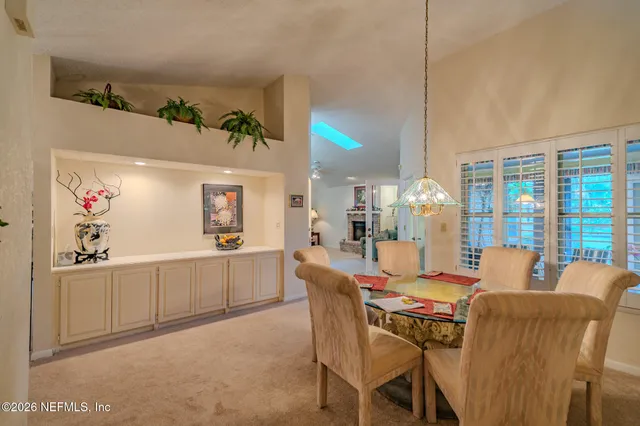 a dining room with furniture and window