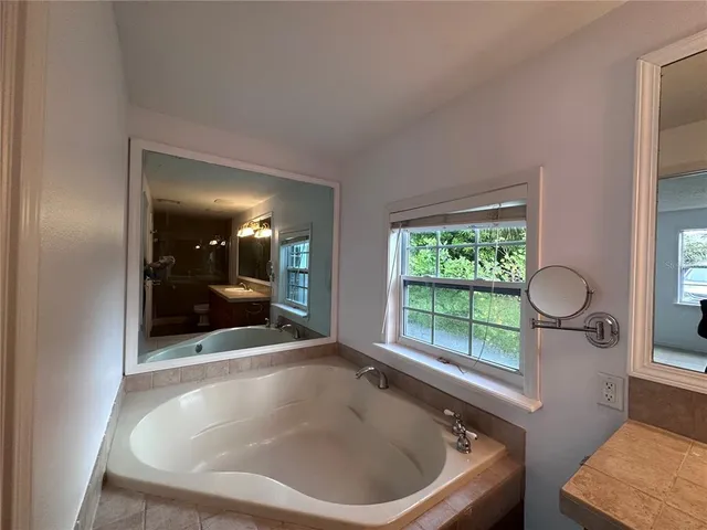 a bath tub sitting in a bathroom next to a window