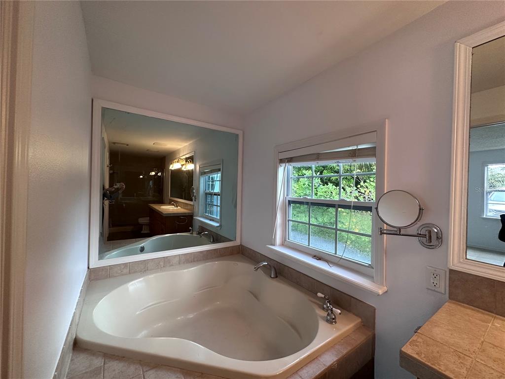 315 Sunburst Court Clearwater, FL 33755 - Photo 14 of 23 a bath tub sitting in a bathroom next to a window