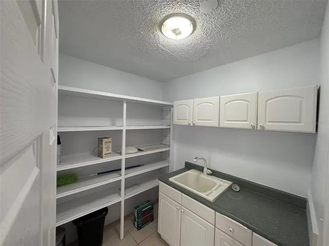 a kitchen with a sink and a microwave
