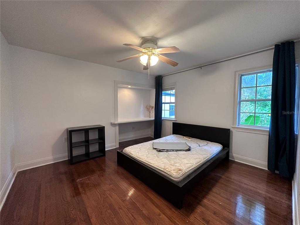 315 Sunburst Court Clearwater, FL 33755 - Photo 7 of 23 a living room with hard wood floors a bed and a chandelier