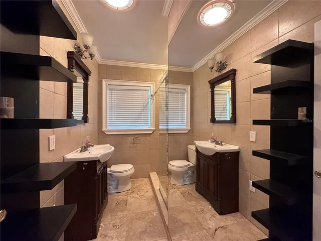 a bathroom with a sink toilet and mirror