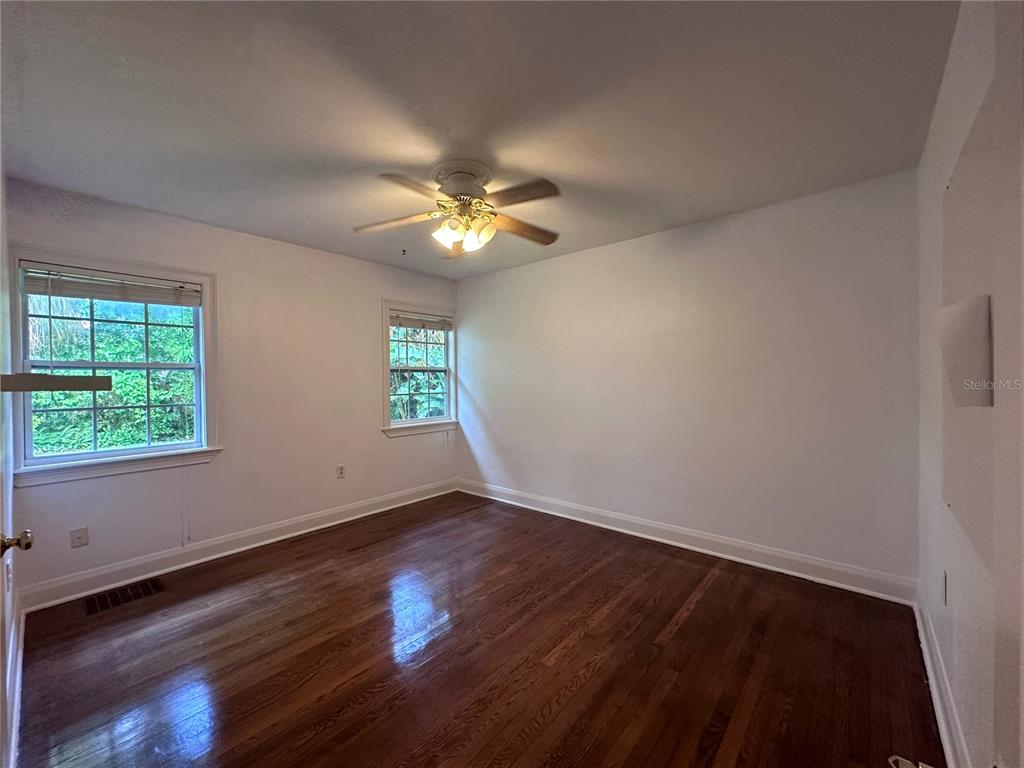 315 Sunburst Court Clearwater, FL 33755 - Photo 9 of 23 a view of an empty room with wooden floor and a window