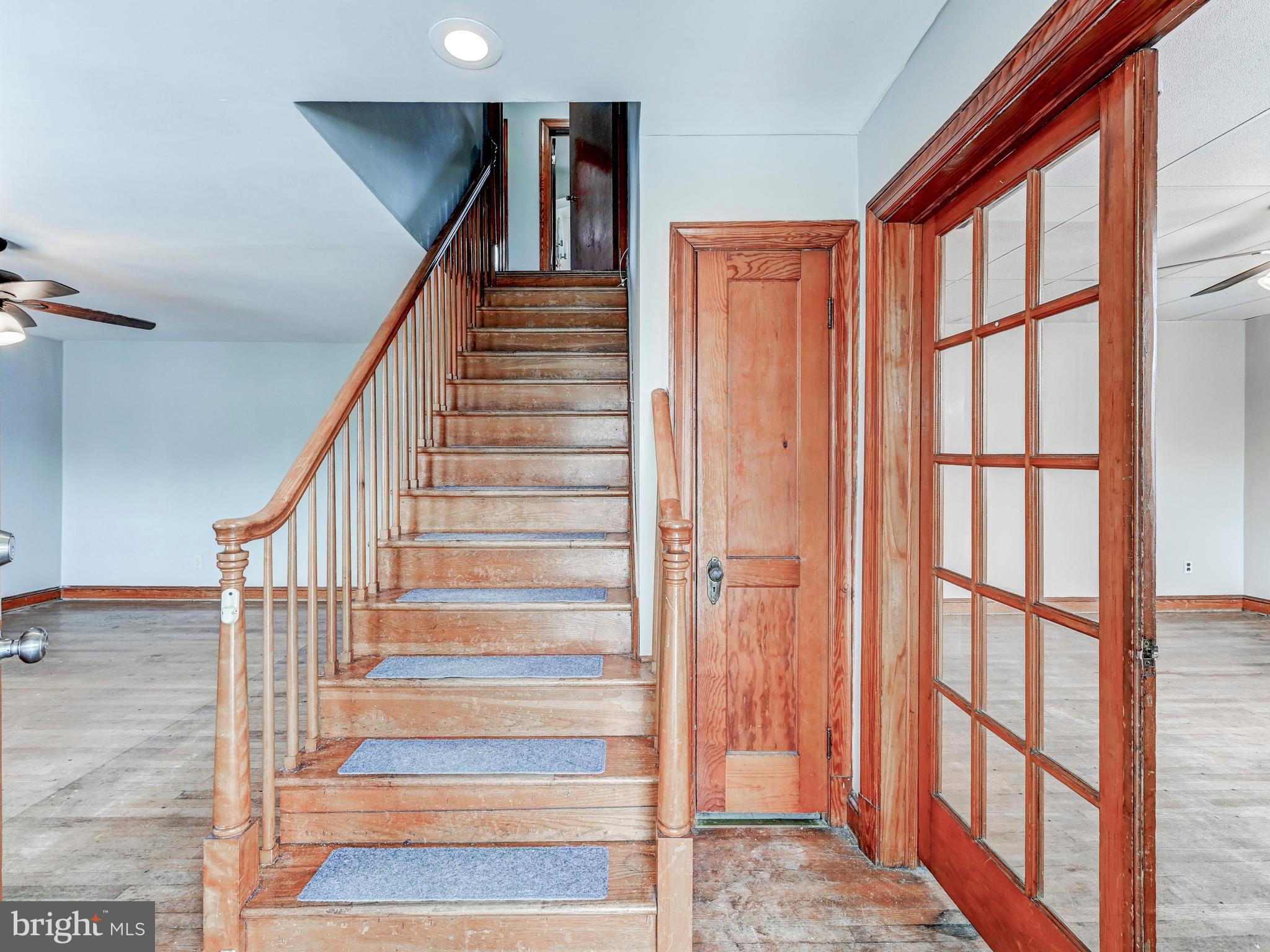 3206 Lynch Road Baltimore, MD 21219 - Photo 22 of 70 a view of staircase with lots of frames on wall and windows