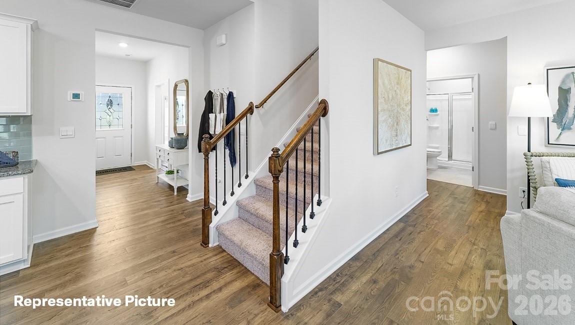 441 Frozen Dream Road Salisbury, NC 28147 - Photo 6 of 35 a view of a hallway with wooden floor and staircase