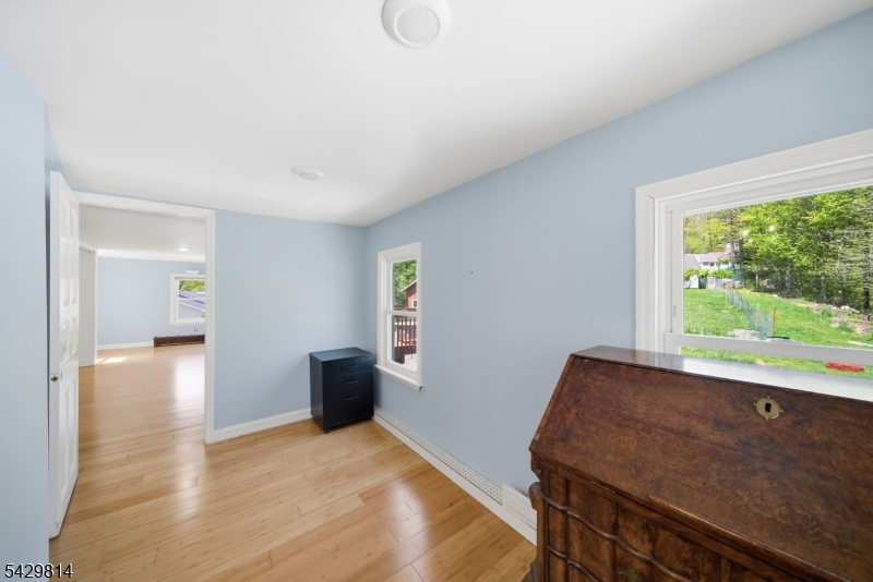 251 Russia Road Oak Ridge, NJ 07438 - Photo 16 of 34 a view of a livingroom with wooden floor and a window