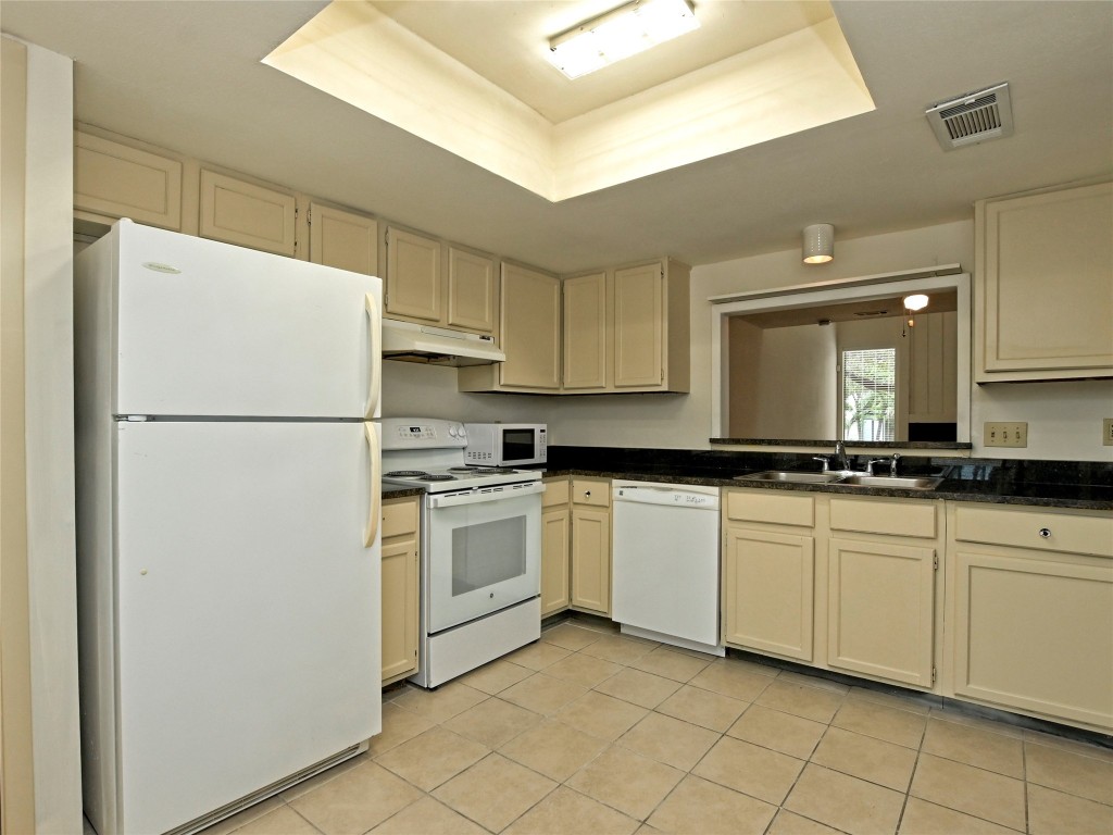 3 Casa Verde Street Lakeway, TX 78734 - Photo 11 of 30 a kitchen with white cabinets and white appliances