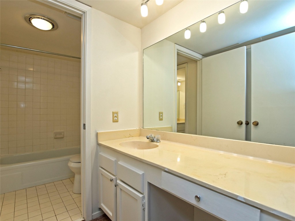 3 Casa Verde Street Lakeway, TX 78734 - Photo 20 of 30 a bathroom with a granite countertop sink a toilet and shower