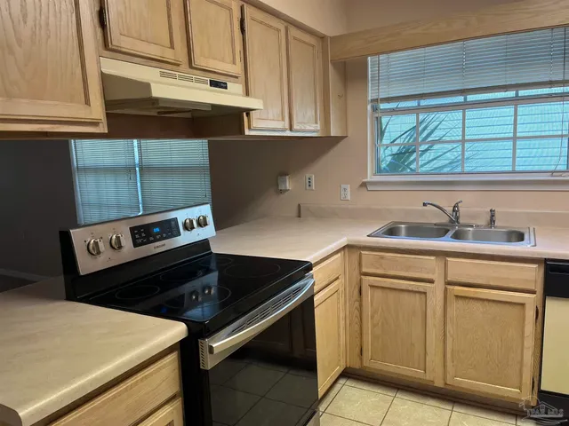 a kitchen with a stove microwave and sink