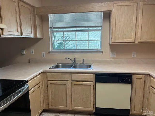 a kitchen with white cabinets and a sink