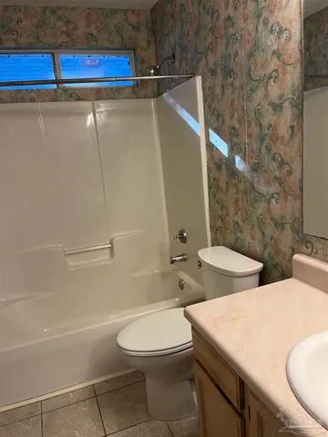 a bathroom with a toilet a sink and bathtub