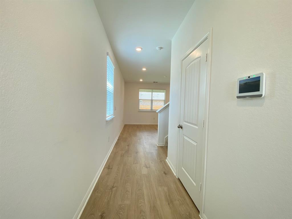 225 Saide Street Georgetown, TX 78626 - Photo 2 of 22 a view of a hallway with wooden floor and staircase