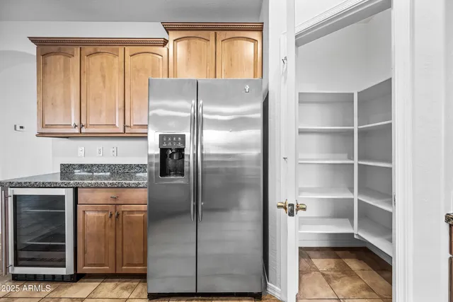 a kitchen with stainless steel appliances granite countertop a refrigerator and a stove
