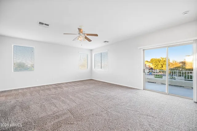 a view of a livingroom with a ceiling fan and window