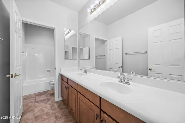 a utility room with sink dryer and washer