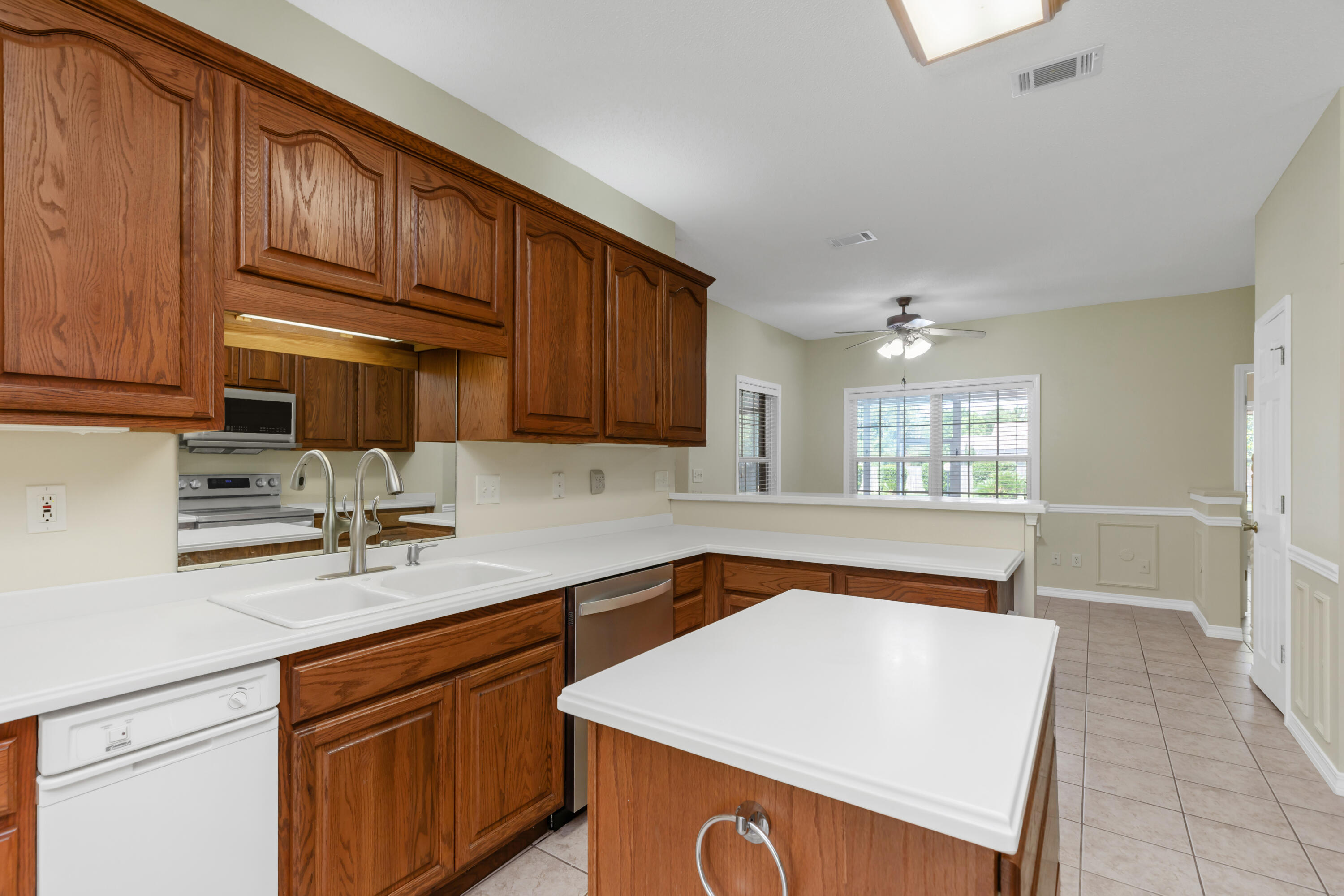5552 Frontier Drive Crestview, FL 32536 - Photo 17 of 54 a kitchen with stainless steel appliances granite countertop a sink dishwasher stove top oven and cabinets with wooden floor