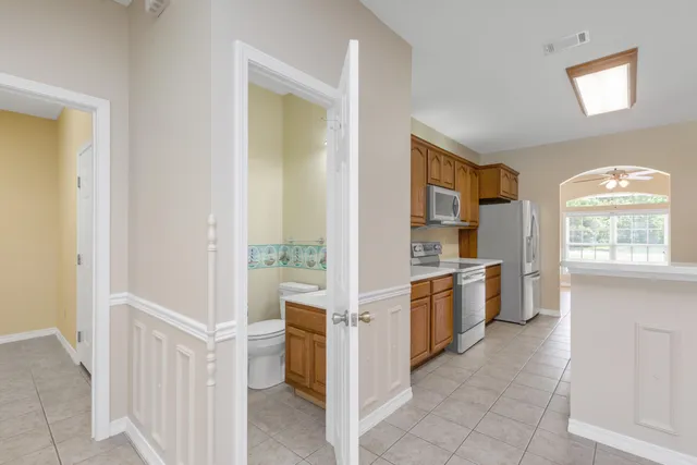 an empty room with a chandelier fan