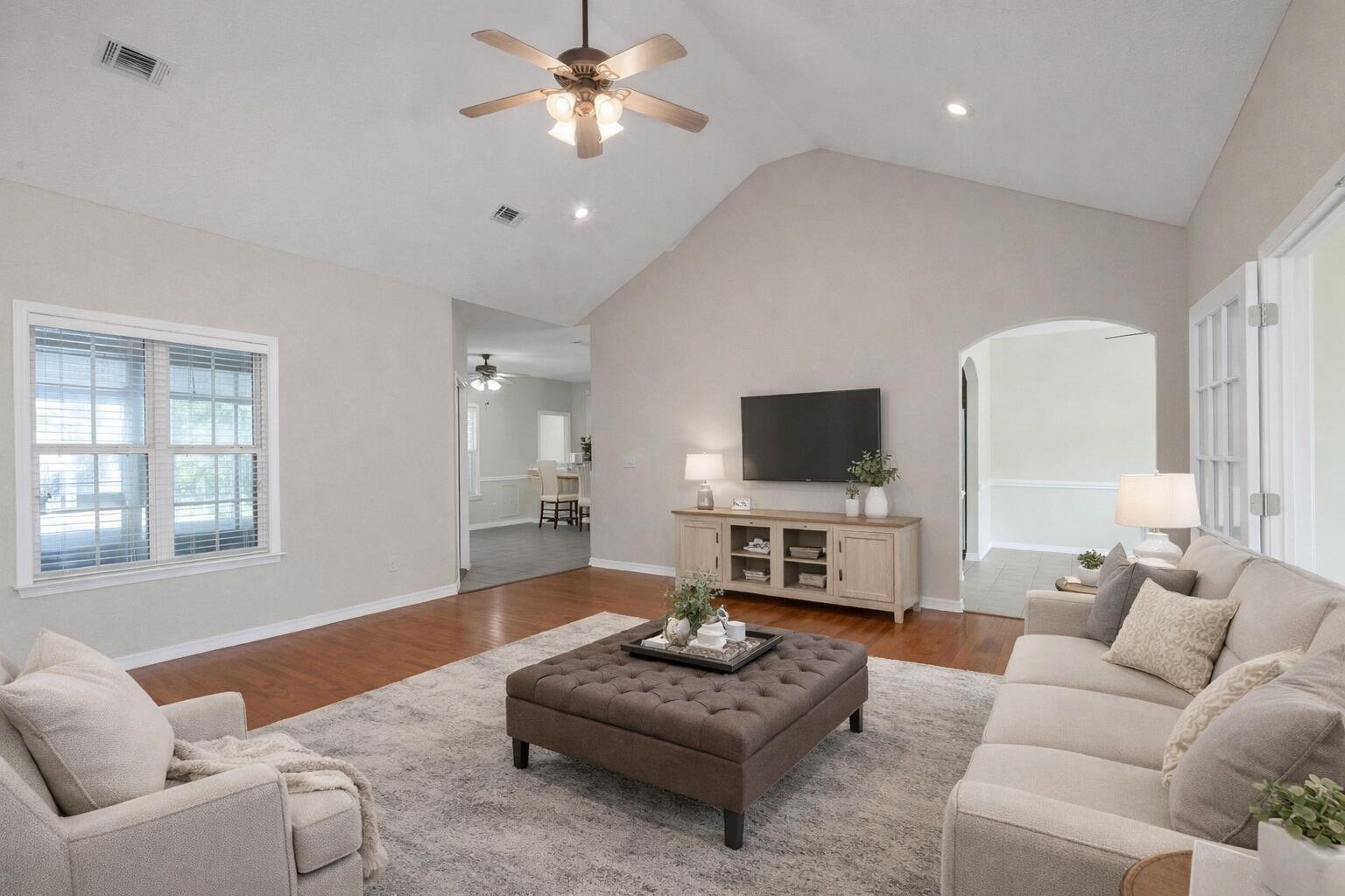 5552 Frontier Drive Crestview, FL 32536 - Photo 10 of 54 a living room with furniture a flat screen tv and a large window