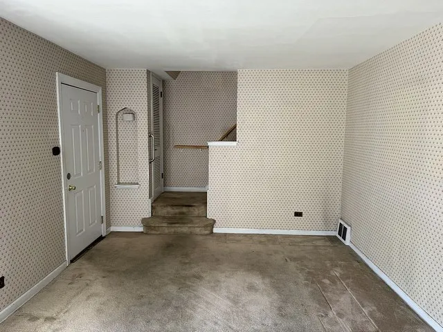 a view of an empty room with a window