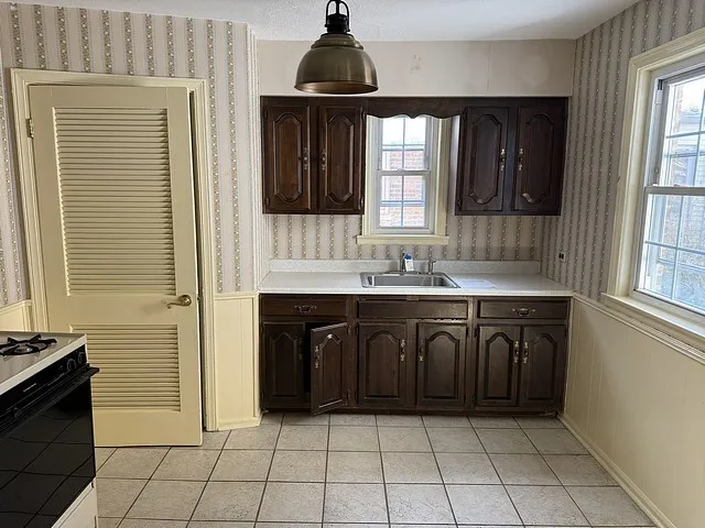 a stove top oven sitting inside of a kitchen