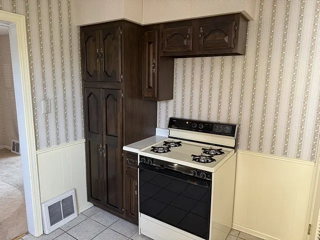 a kitchen with a sink a stove and a microwave