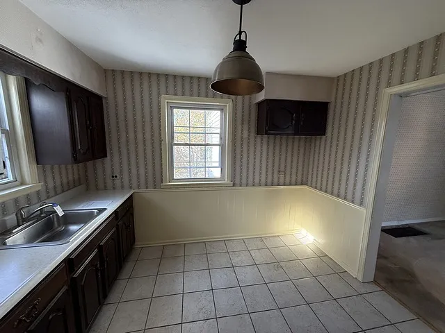 a view of an empty room with a fireplace and a window
