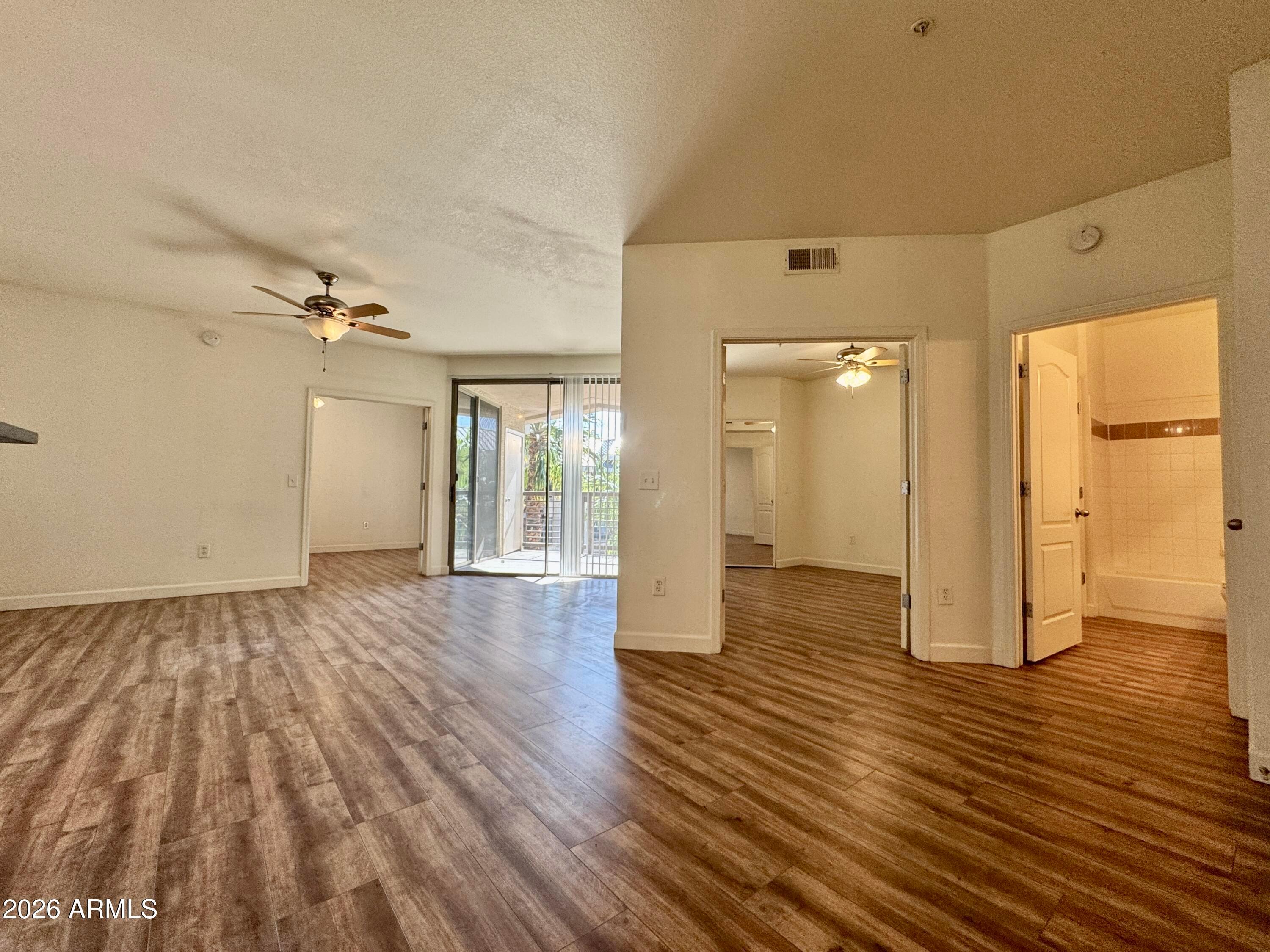 1701 East Colter Street, Unit 465 Phoenix, AZ 85016 - Photo 13 of 25 a view of a big room with wooden floor and windows